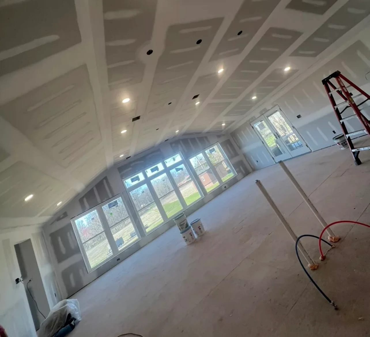 Professional new construction drywall installation with precision framing and modern building techniques